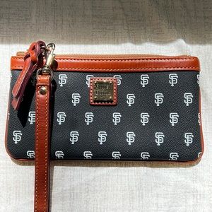 Dooney & Bourke San Francisco Giants wristlet bag with red interior.